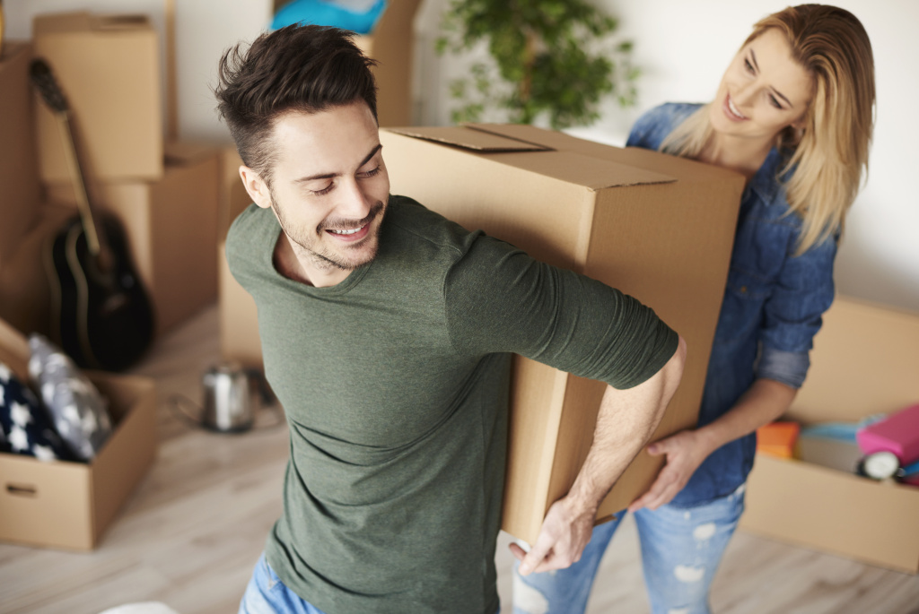 couple-carrying-heavy-moving-boxes-together.jpg